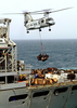 A Ch-46 Sea Knight Helicopter Delivers Supplies From The Fast Combat Support Ship Uss Bridge (aoe 10) To The Aircraft Carrier Uss Constellation (cv 64) During An Underway Replenishment Image