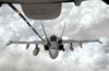 A U.s. Navy F/a-18 Hornet Strike Fighter Flying Missions In Operation Iraqi Freedom Receives Fuel From A Kc-10 Extender. Image