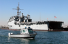 Security Personnel Patrol The Waters Of Anaheim Bay While The Amphibious Transport Dock Ship Uss Denver (lpd 9) Takes On Ammunition. Image