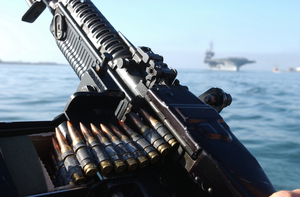 Uss Constellation (cv 64) Framed By An M-60 Machine Gun Image