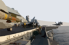An F/a-18c Hornet, Loaded With A 500-pound Gbu-12 Laser-guided Missile, Moves Into Position While Another Launches From One Of Four Steam Powered Catapults Aboard The Uss Kitty Hawk (cv 63) Clip Art